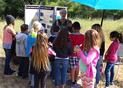 Kathe Hustace of Amigos de Anza participates as a docent in the curriculum-based field trip at Adobe Springs.