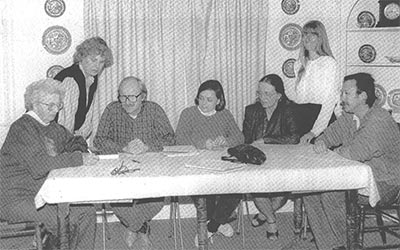 Marj Mackey signing the incorporation papers in 1991.  Board Members (L to R): Marj Mackey, Lindsay Hampton, David Brown, Val Houdyshell, Joan O'Keefe, Ursula Luna, Dennis Loftus.  Missing was Karen Riggs and Gail Pollard. 